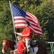 veteran with flag on horse