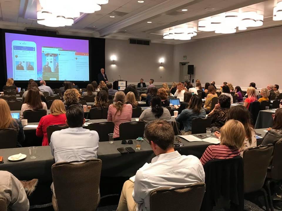 conference session with powerpoint on screen in front of audience