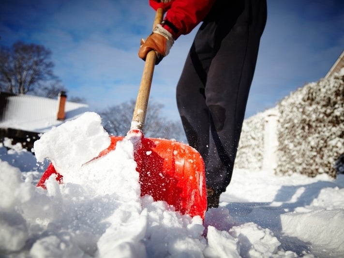 Picture of someone shoveling snow, taken from a ground-level perspective
