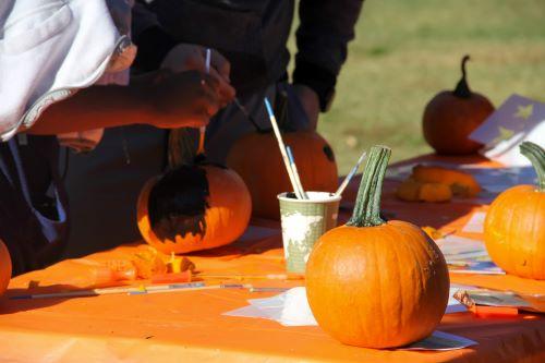 pumpkins on table with paints and crafts