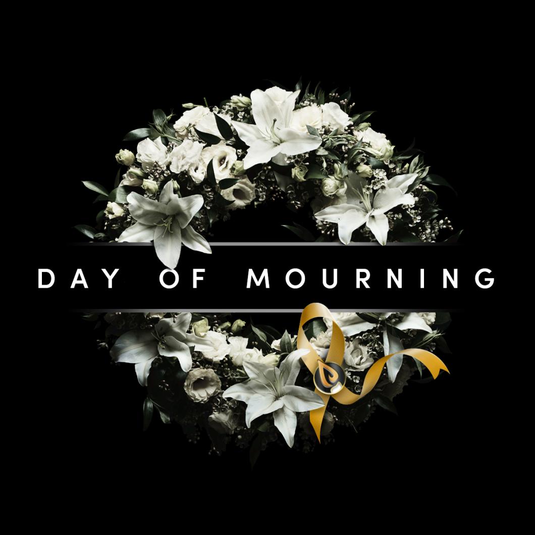 A wreath of flowers with "Day of mourning" across the middle