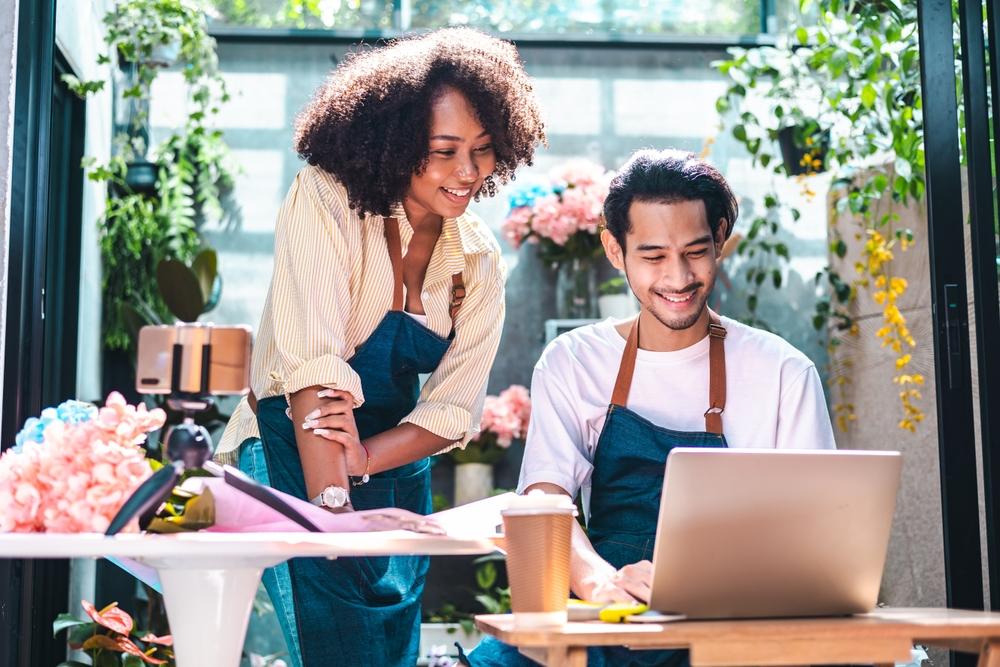 Two florists look at their laptop