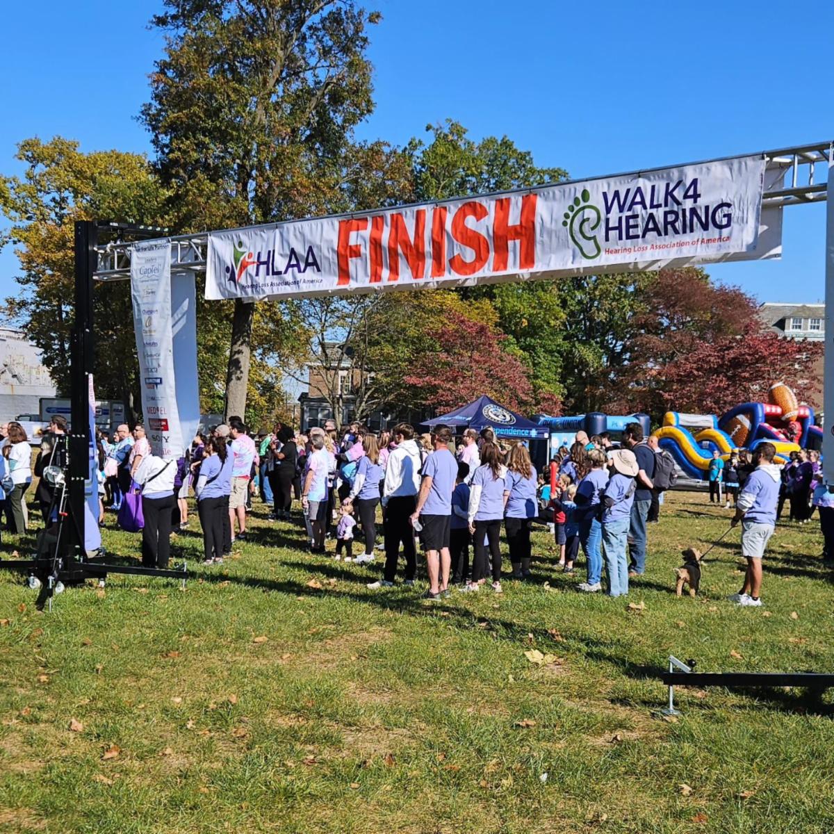 A crowd of people outside under a "Finish" line sign.