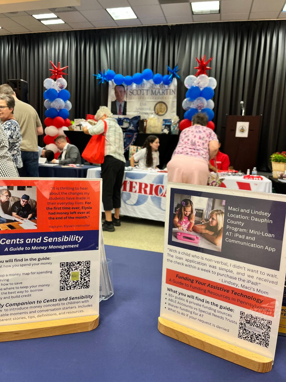 Sen. Scott Martin Senior Expo. Balloon arch with PATF materials on the table.