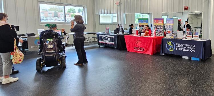 There are several resource tables, including PATF's. There are attendees walking around.