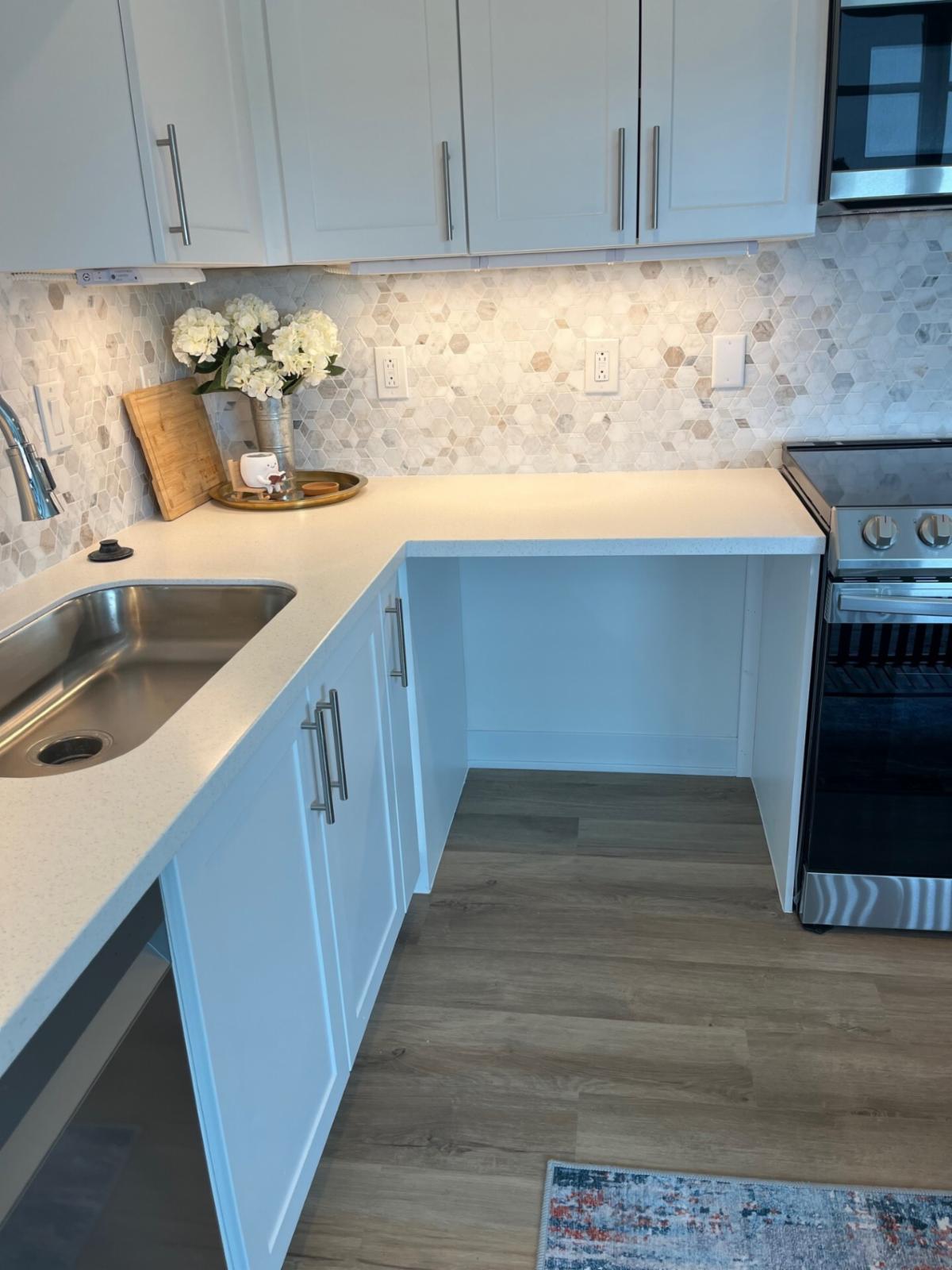 An accessible kitchen with a cabinet cut out at The Tower at Henry Avenue.