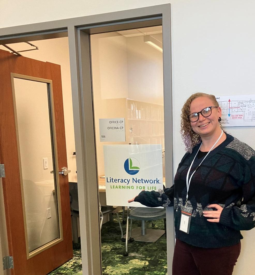 Staff show the Literacy Network sign at the new Reindahl office