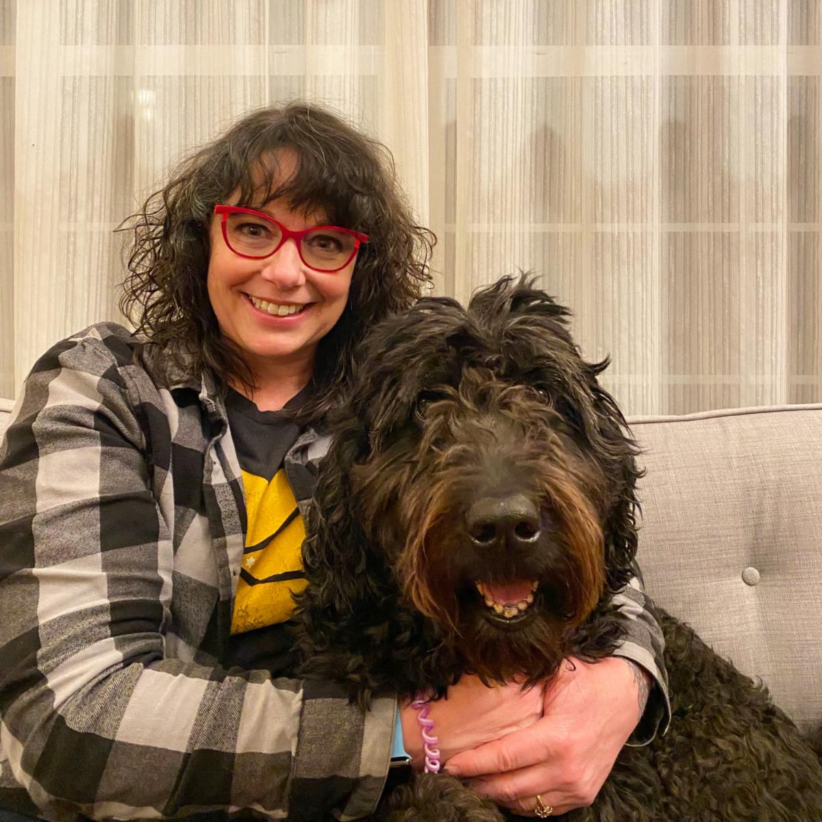 Photo of our event manager, Tracy! with her large curly dog.