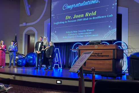 Joan Reid on stage receiving her award