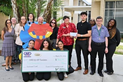 Fund it Foward's executive board members present $500 check to the staff at CARD-USF.