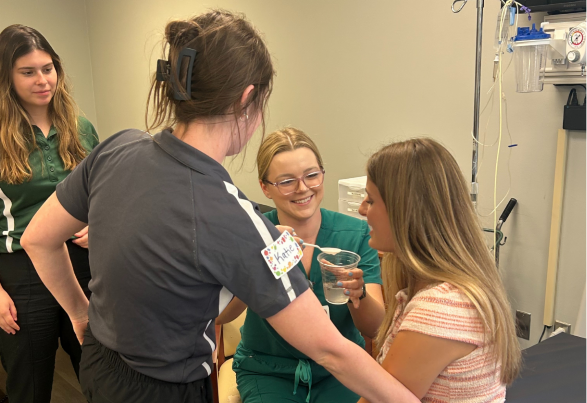 A group of students participating in a hands on clinical training exercise