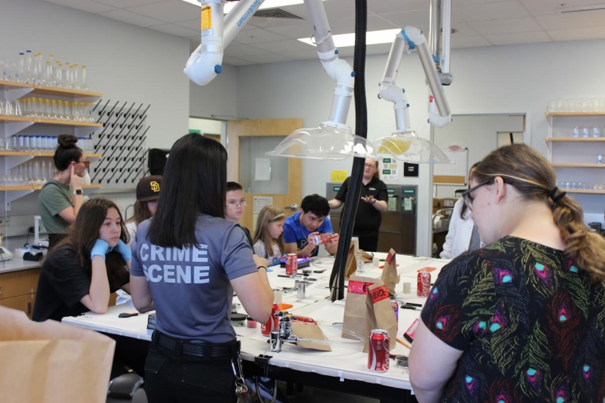 Staff provides guidance to students during a crime scene scenario exercise at the "Fur-ensic: A Canine Crime Scene Investigation" on the USF Sarasota-Manatee campus.