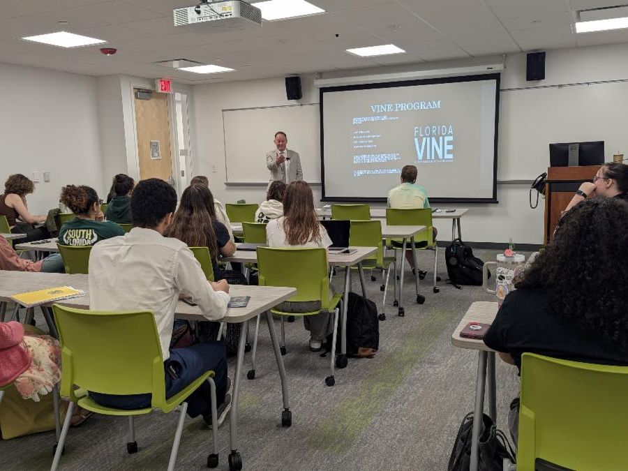 Chris Jeffords speaking to criminology students with a presentation behind him