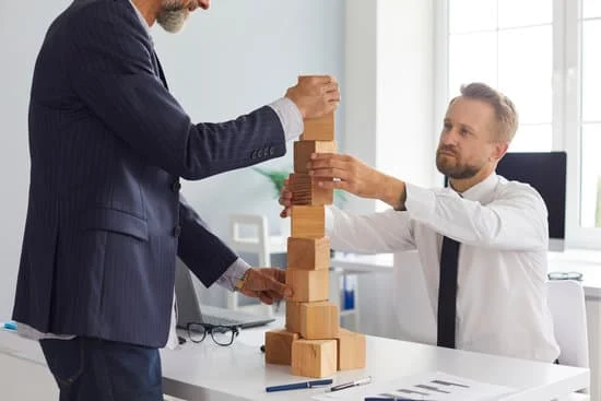 businessmen with stack of blocks