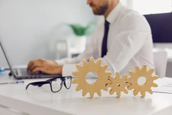 man at laptop with cogwheels