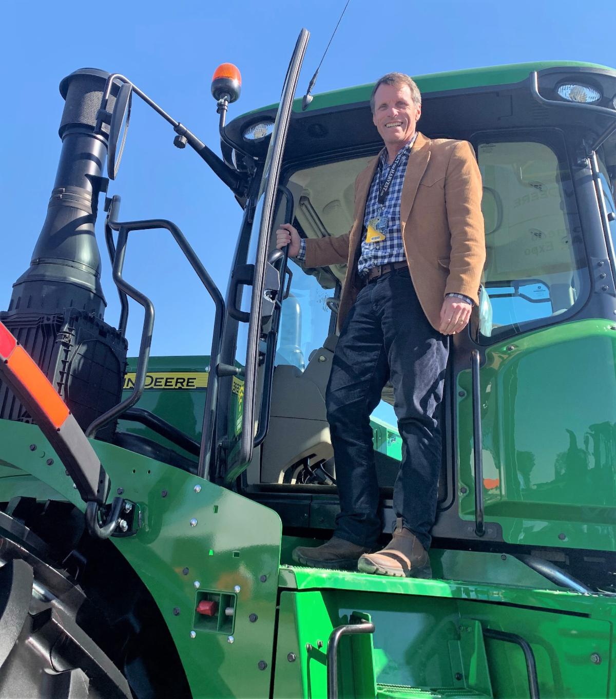 Ted Gaines on large green John Deere tractor at the World Ag Expo 2020 in Tulare California