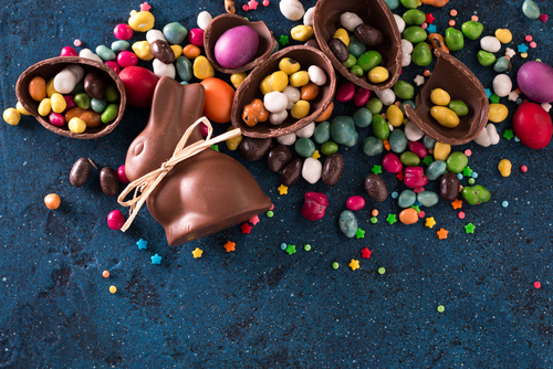 Delicious chocolate easter eggs _bunny and sweets on dark blue background