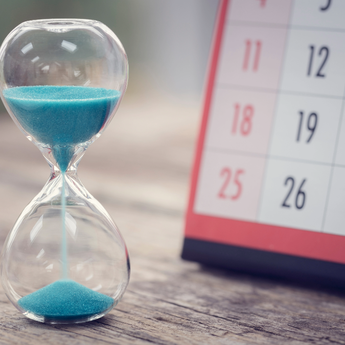 an hourglass next to a calendar
