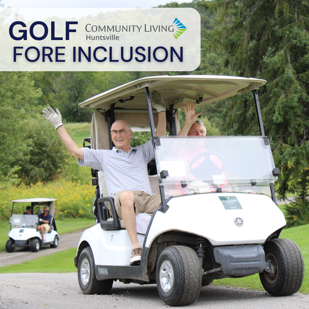2 smiling men in a golf cart waving their hands in the air. Text reads, "Golf Fore Inclusion"