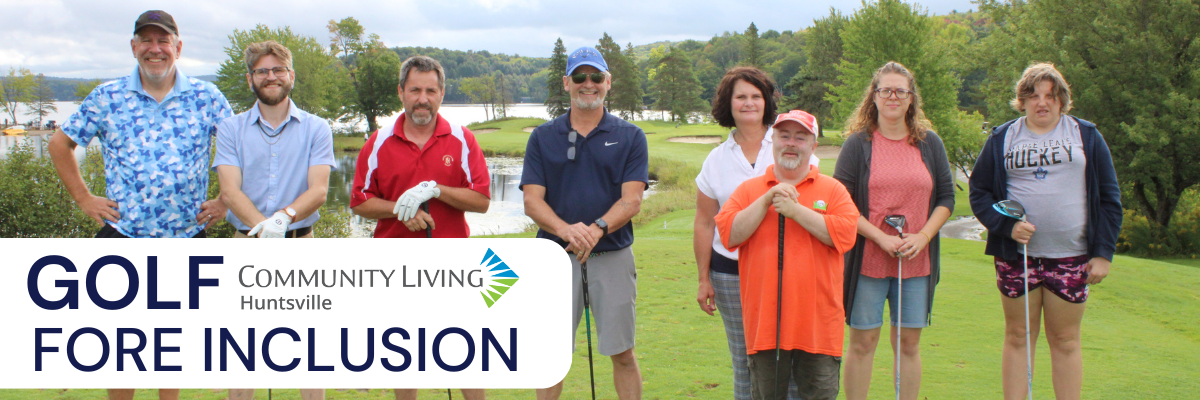 Group of people on a golf course with lake and trees behind