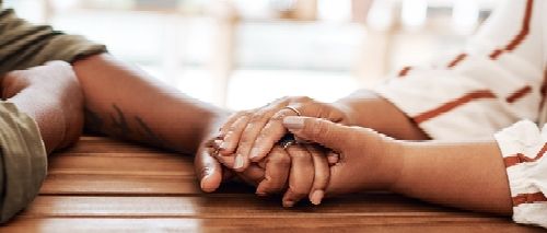 People_ hands or wood desk with empathy for relationship_ love or trust in house. Couple_ together or solidarity in home with support or kindness_ helping others with comfort or prayer in living room