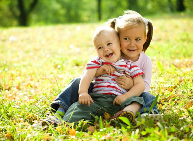 kids_hugging_on_grass.jpg