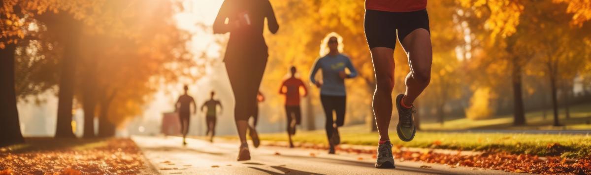 joggers running on path with autumn leaves