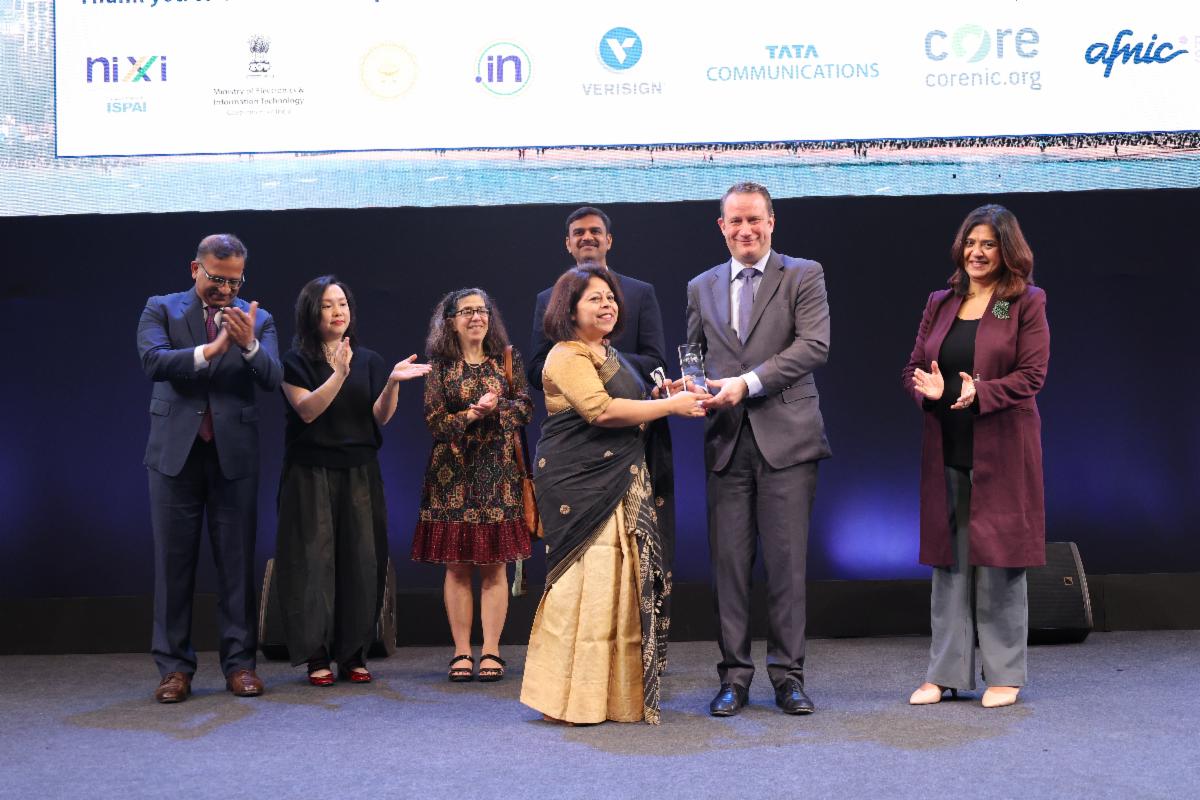 Amrita Choudhury accepts the Community Excellence Award from ICANN President and CEO Kurtis Lindqvist at the ICANN85 Community Forum Opening Ceremony.