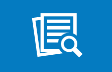 Image of a white piece of paper and magnifying glass on a blue background