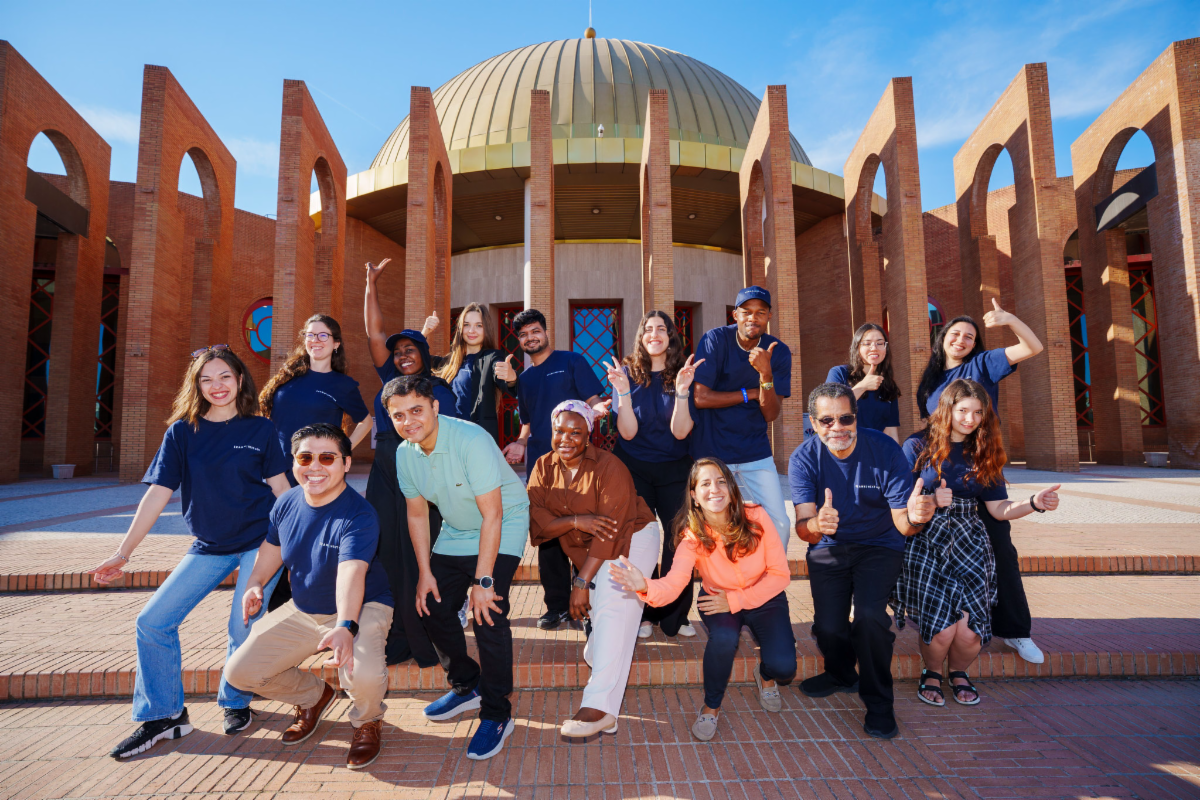 Members of the NextGen@ICANN86 Program cohort gather and pose for their group photo in front of the FIBES building in Seville, Spain.