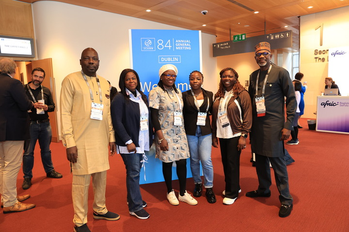 ICANN84 participants gather for a group photo in front of the meeting welcome banner.