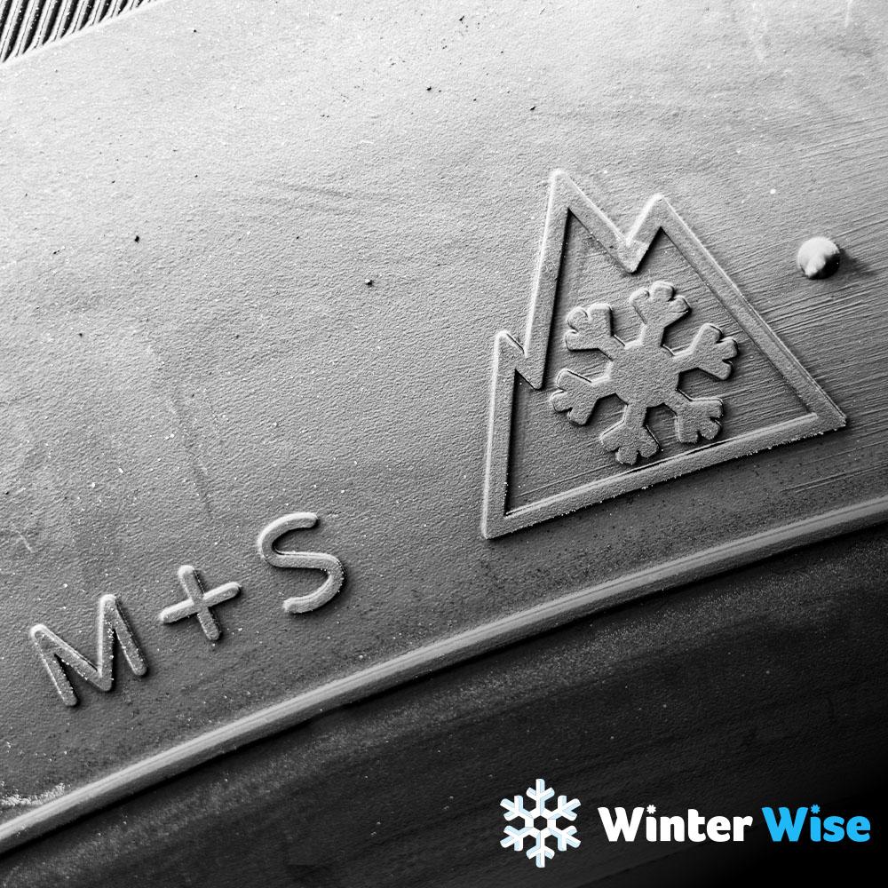A close up image of a tire showing the M+S icon. 