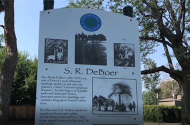Sign in public park S.R. DeBoer showcasing historical photos and information on the park's namesake.