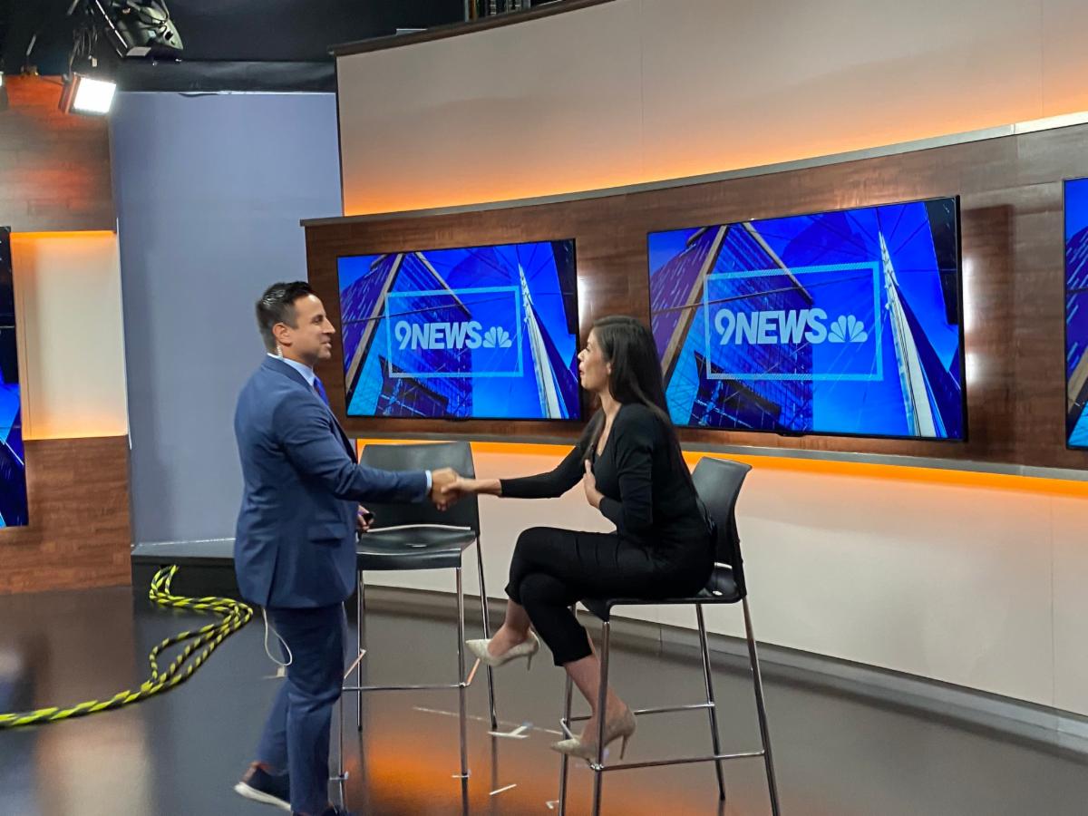 Financial Expert Veronica Robles shakes hand with 9News Host.