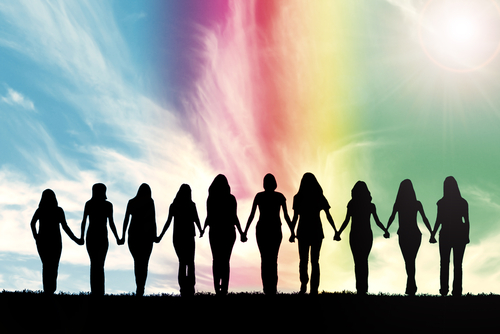 Silhouette of ten young women_ walking hand in hand under a rainbow sky.