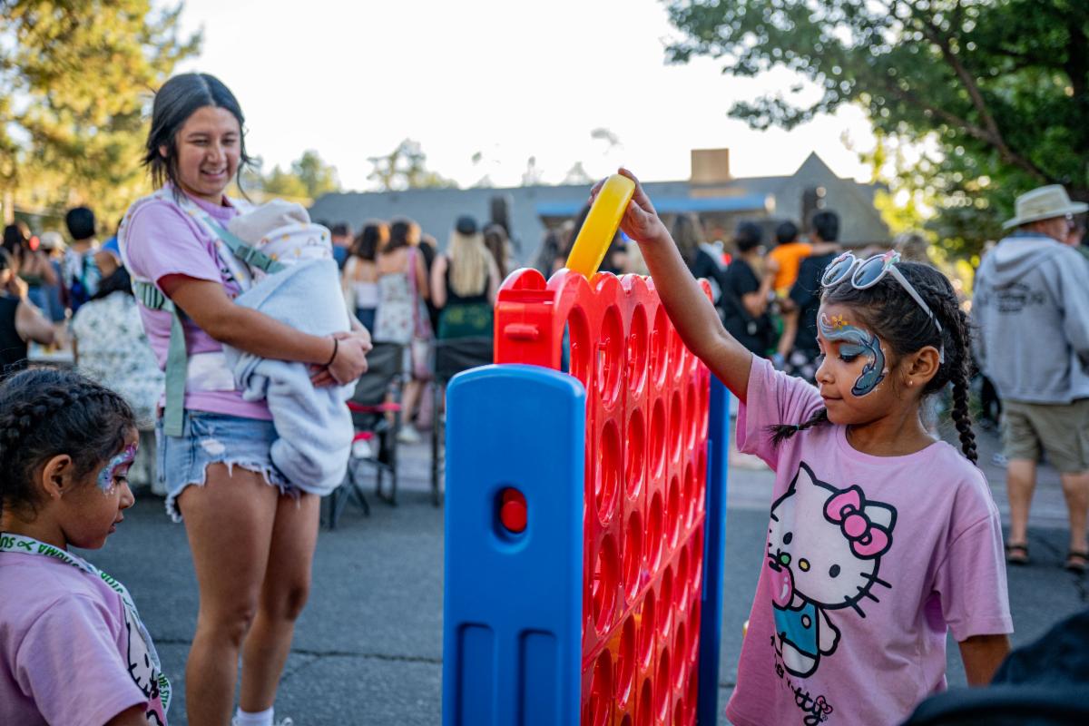 A family playing a life-sized Connect 4 game