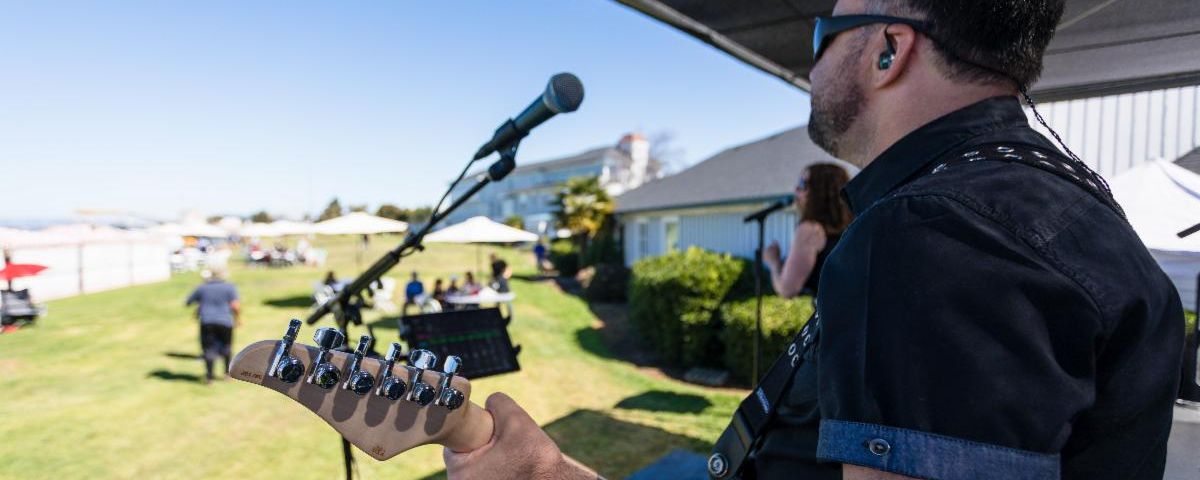 Person playing guitar on stage.