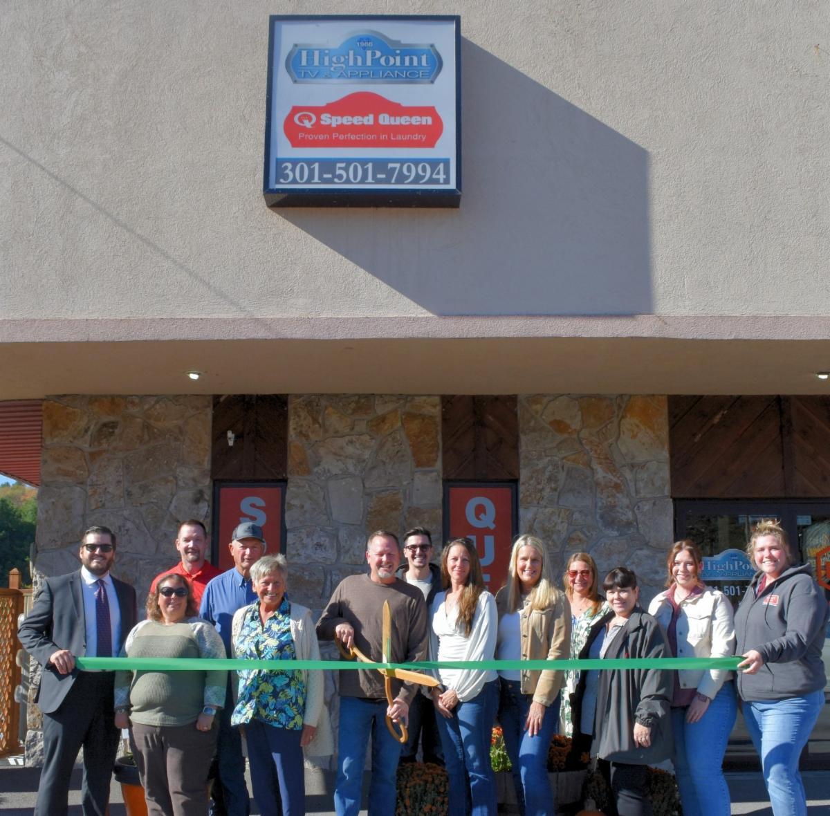 Men and women celebrating a ribbon cutting for HighPoint TV and Appliance.