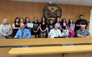 Photo of Cosmic Studios owner and staff being presented a 5-year milestone proclamation by the Garrett County Commissioners.