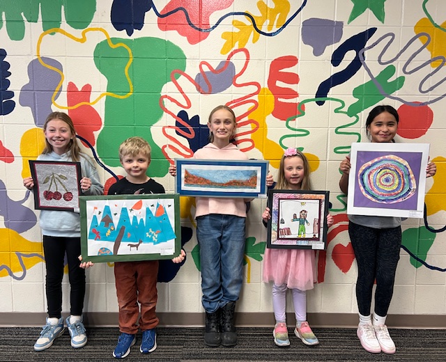 5 students holding their artwork