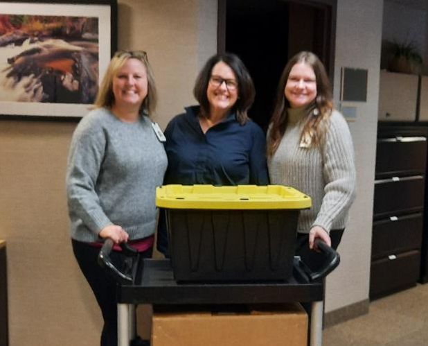 3 women with donation box
