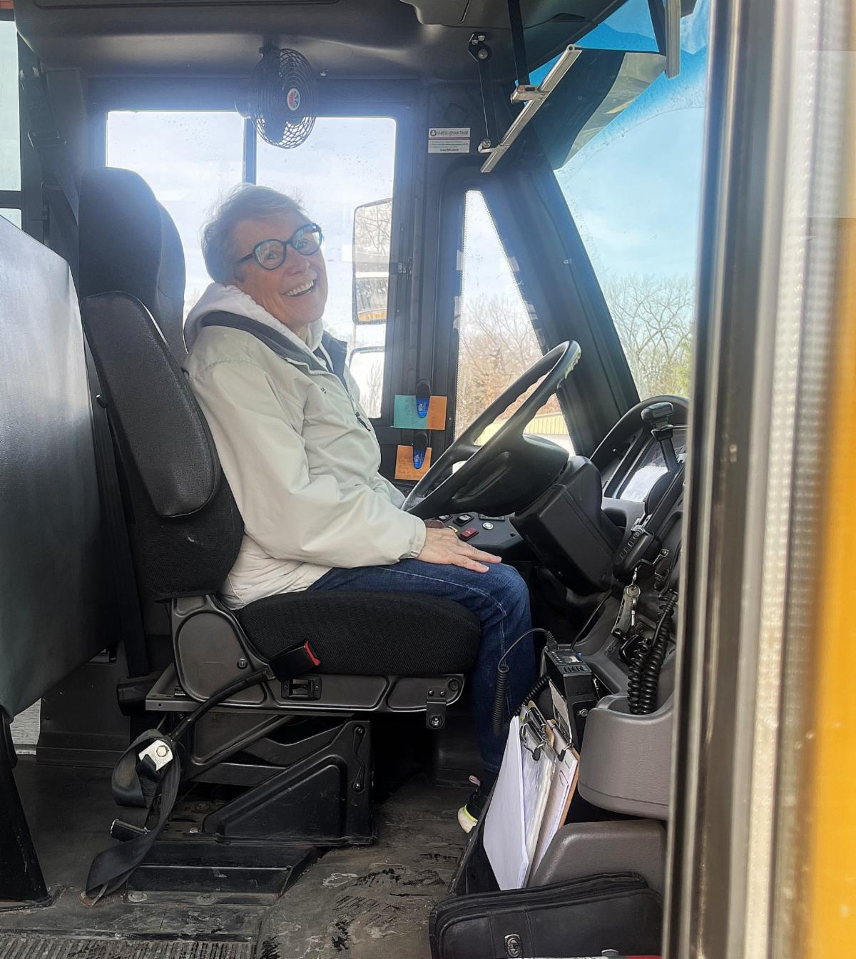 bus driver Mary Waters sitting in the bus driver's seat