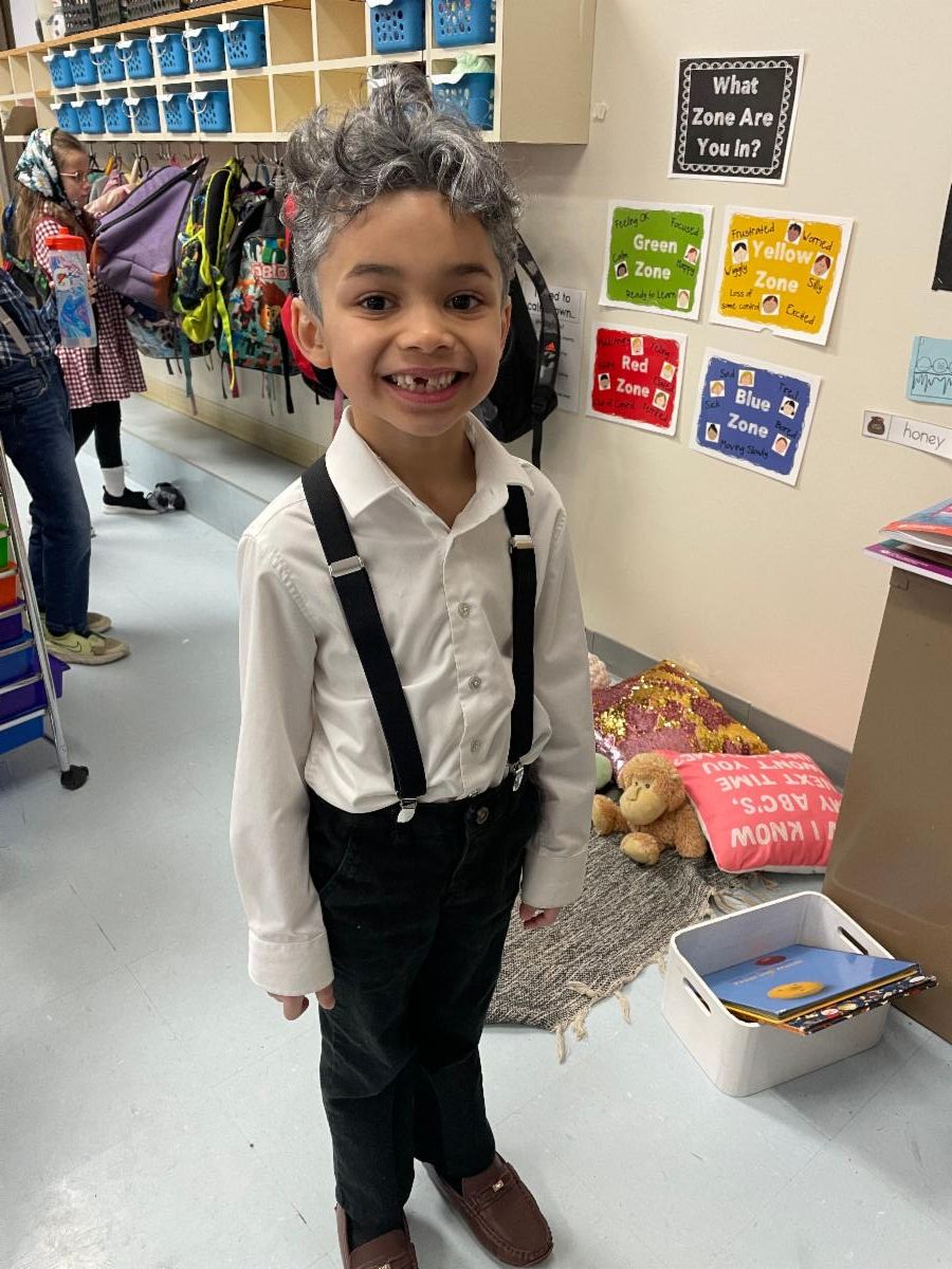 boy in suspenders dressed like an old man