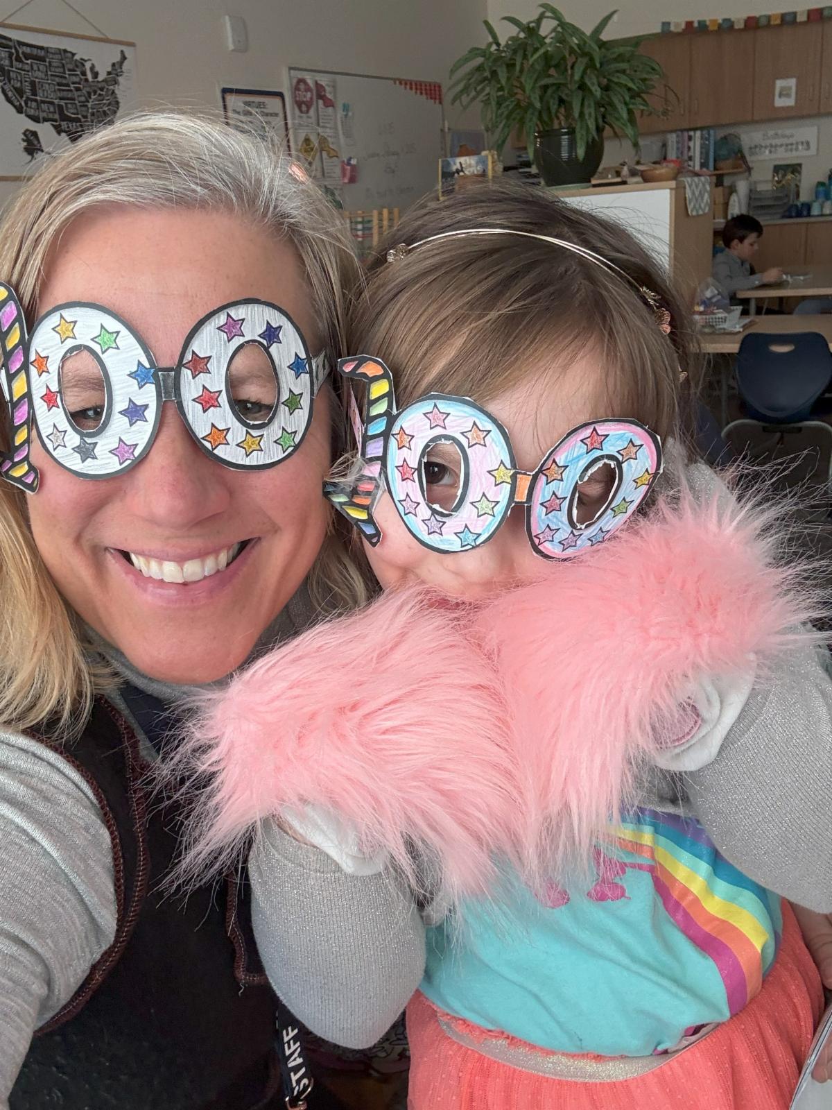 woman and child wearing glasses in shape of 100