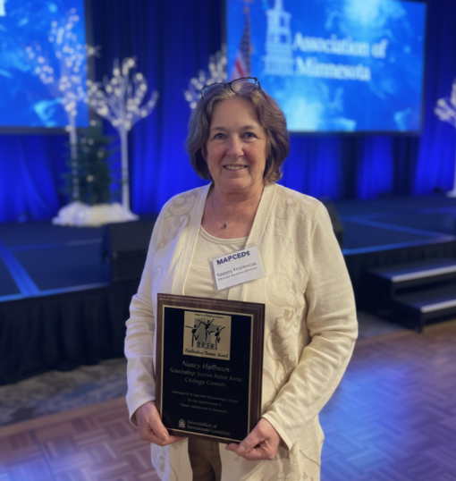 Nancy Hoffman holding an Award Plaque