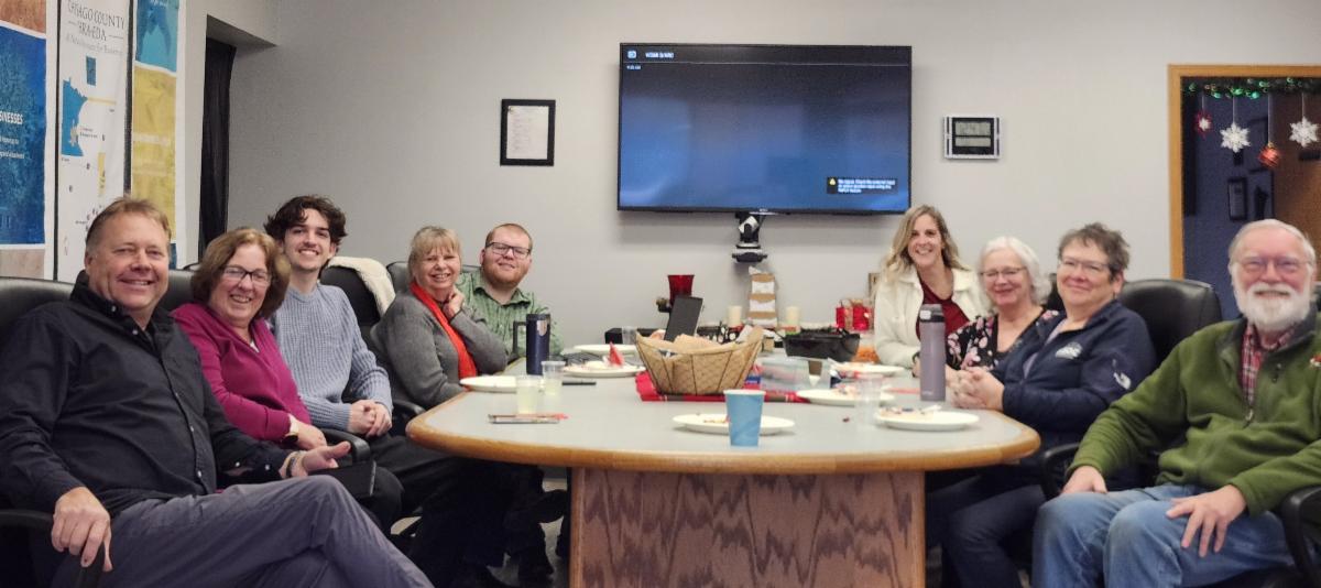 HRA-EDA crew at a table smiling during Christmas