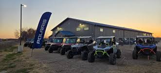 Falcon Powersports Building with ATVs by a sunset in Stacy MN