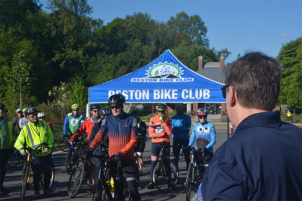 Fairfax County Supervisor Walter Alcorn talking to bikers at 2026 Tour de Hunter Mill
