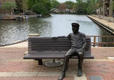 Robert Simon sitting on bench at Lake Anne Plaza
