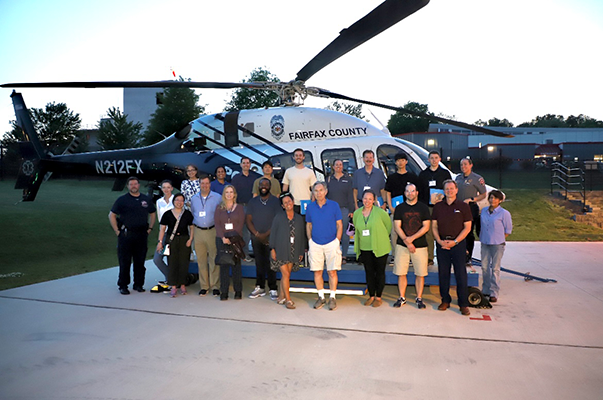 Community Police Academy class standing in front of a helicopter